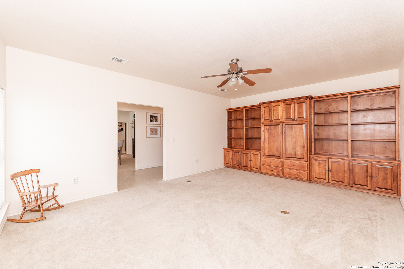 511 County Road 423 D'Hanis, TX 78850 - Photo 5 of 47 an empty room with chandelier fan and windows