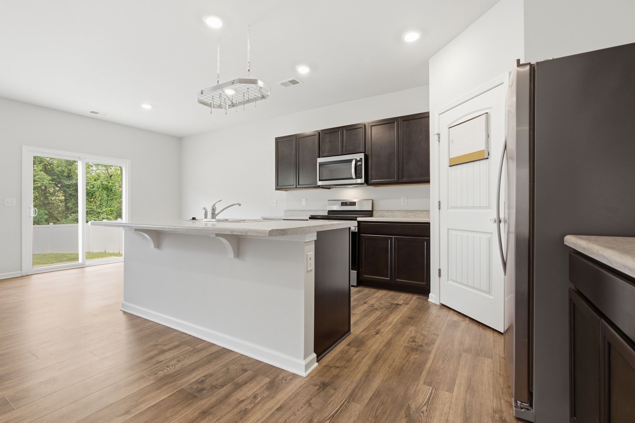 514 Ash Street Lebanon, TN 37087 - Photo 13 of 37 a kitchen with kitchen island white cabinets and stainless steel appliances