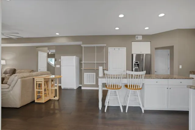 a kitchen with stainless steel appliances granite countertop a sink stove and cabinets