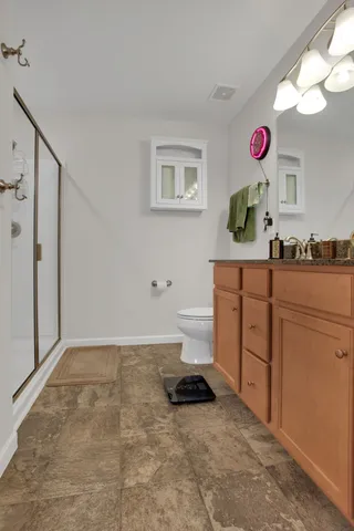 a bathroom with a shower and a glass door