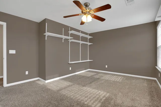 a view of room with a ceiling fan