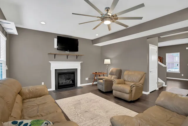 a living room with a fireplace and a flat screen tv