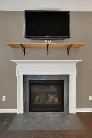 a living room with furniture kitchen view and a chandelier