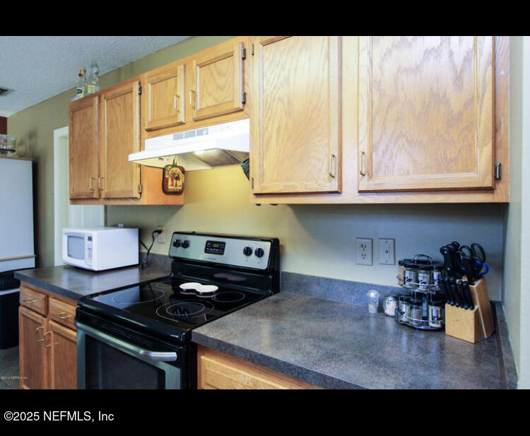 1000 Fleming Street Fleming Island, FL 32003 - Photo 6 of 17 a kitchen with stainless steel appliances granite countertop a stove and a sink