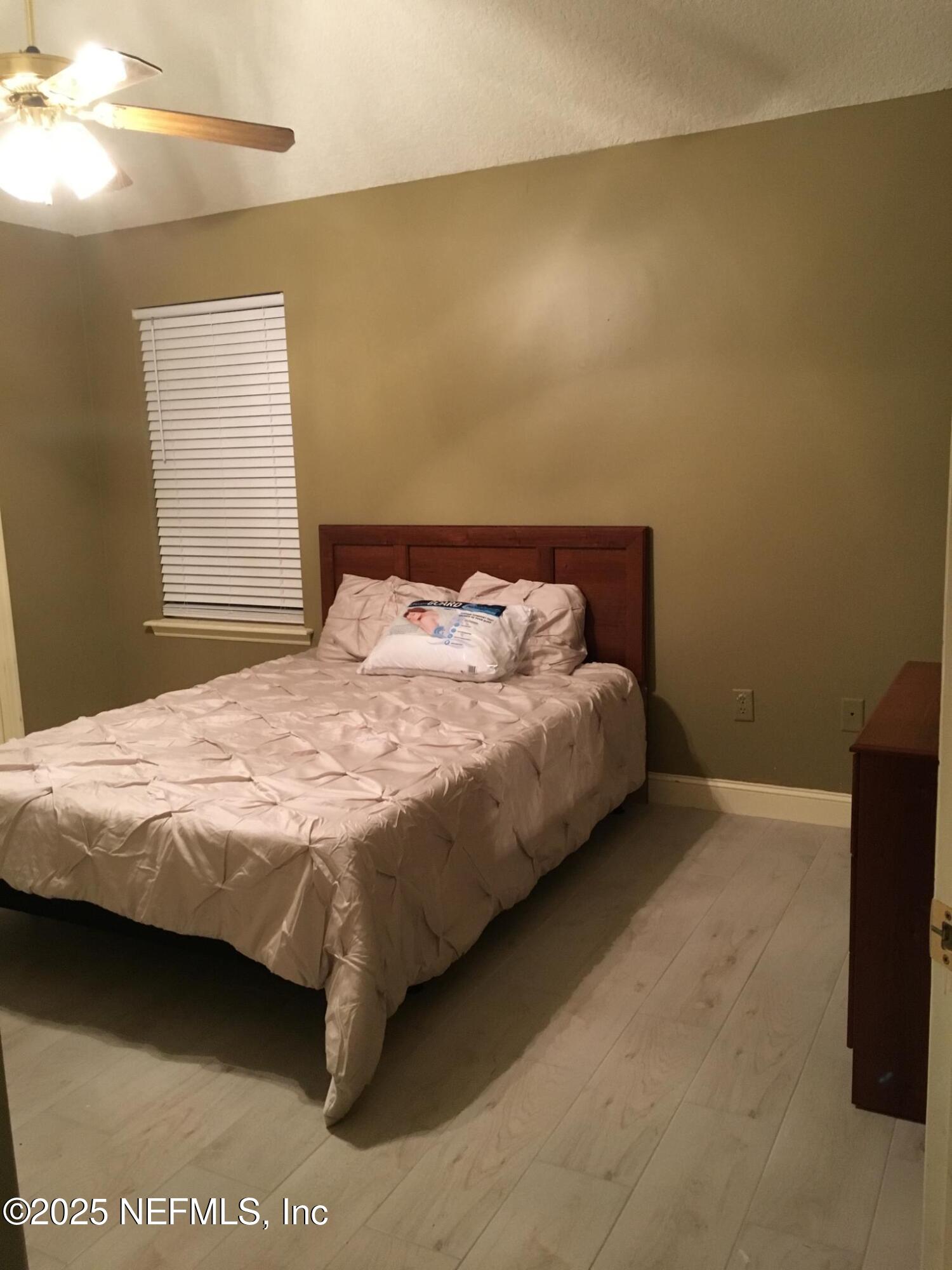 1000 Fleming Street Fleming Island, FL 32003 - Photo 9 of 17 a bed sitting in a bedroom next to a window