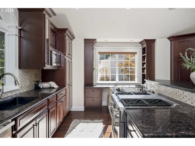 a kitchen that has a sink and a stove