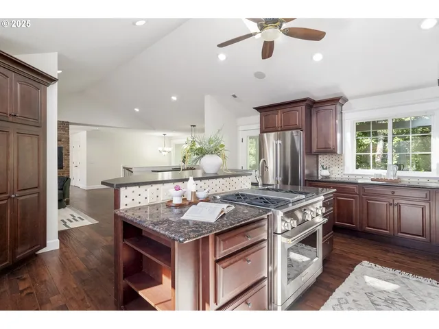 a kitchen with a stove and a wooden floor