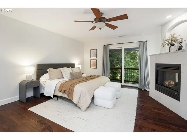 a bedroom with a large bed and a fireplace