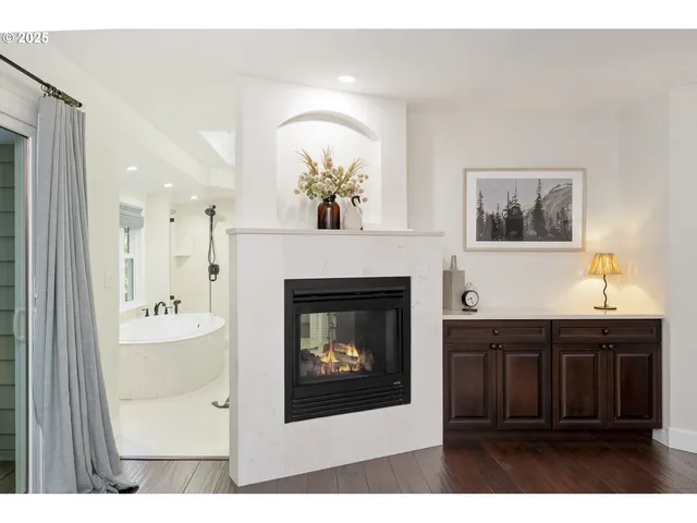 a living room with a fireplace and a chandelier