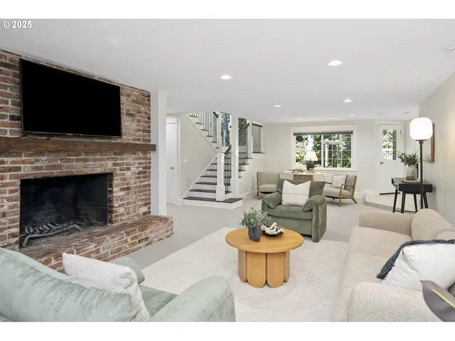 a living room with furniture a flat screen tv and a fireplace