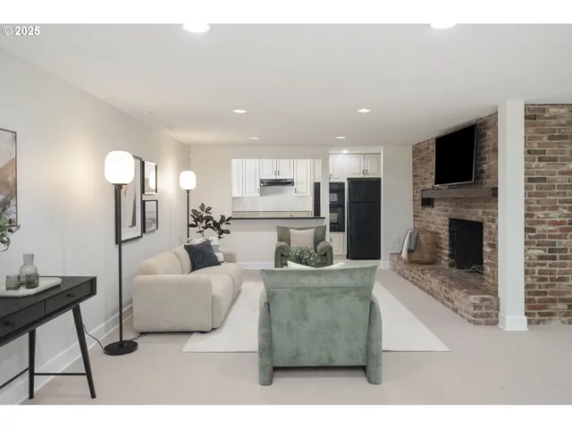 a living room with furniture a flat screen tv and a fireplace