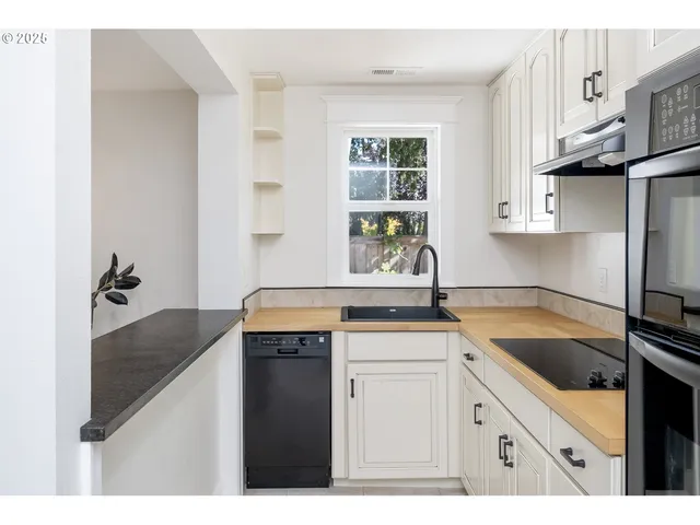 a kitchen with a sink stove and cabinets