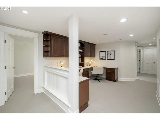 a living room with stainless steel appliances kitchen island furniture and a television