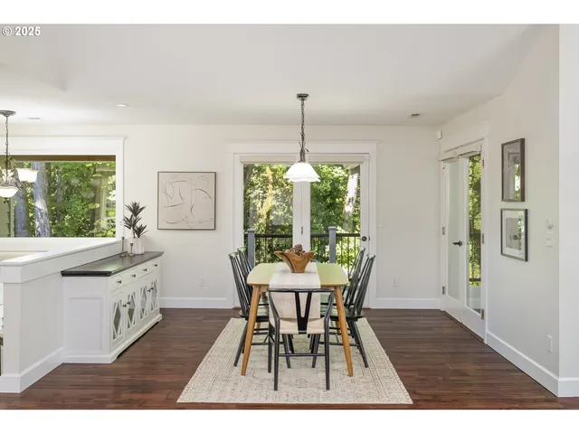 a dining room with furniture a chandelier and wooden floor