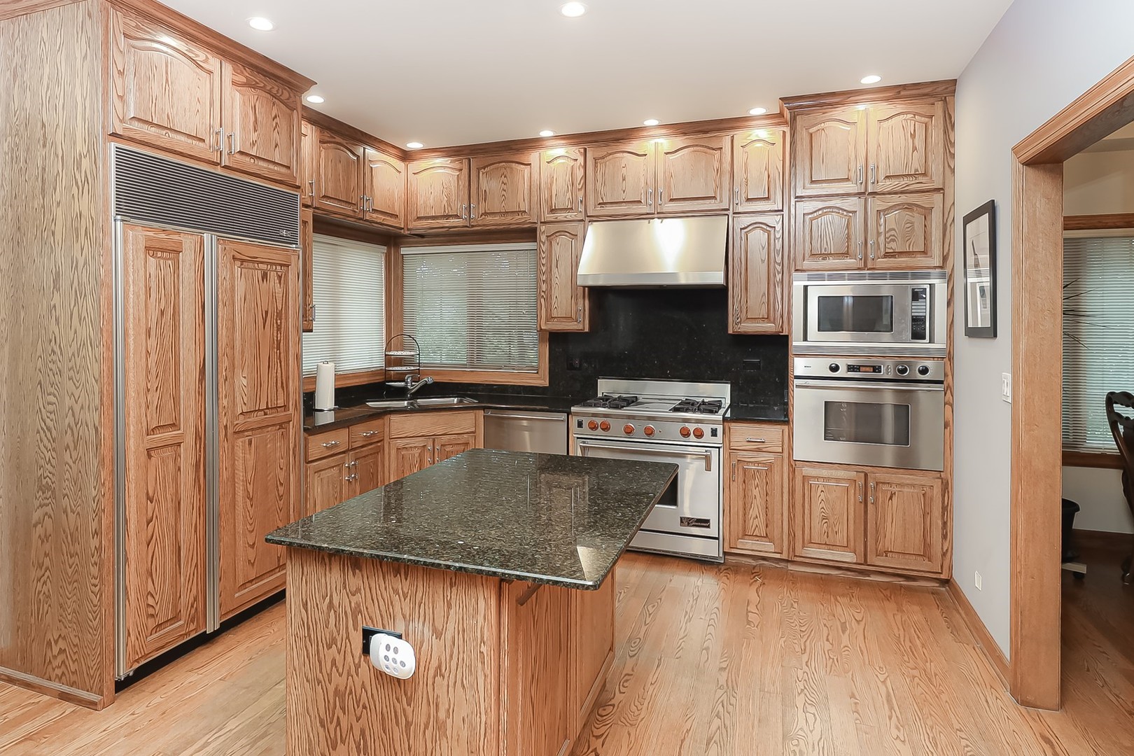 307 79th Street Burr Ridge, IL 60527 - Photo 11 of 41 a kitchen with stainless steel appliances granite countertop a refrigerator a stove and a sink