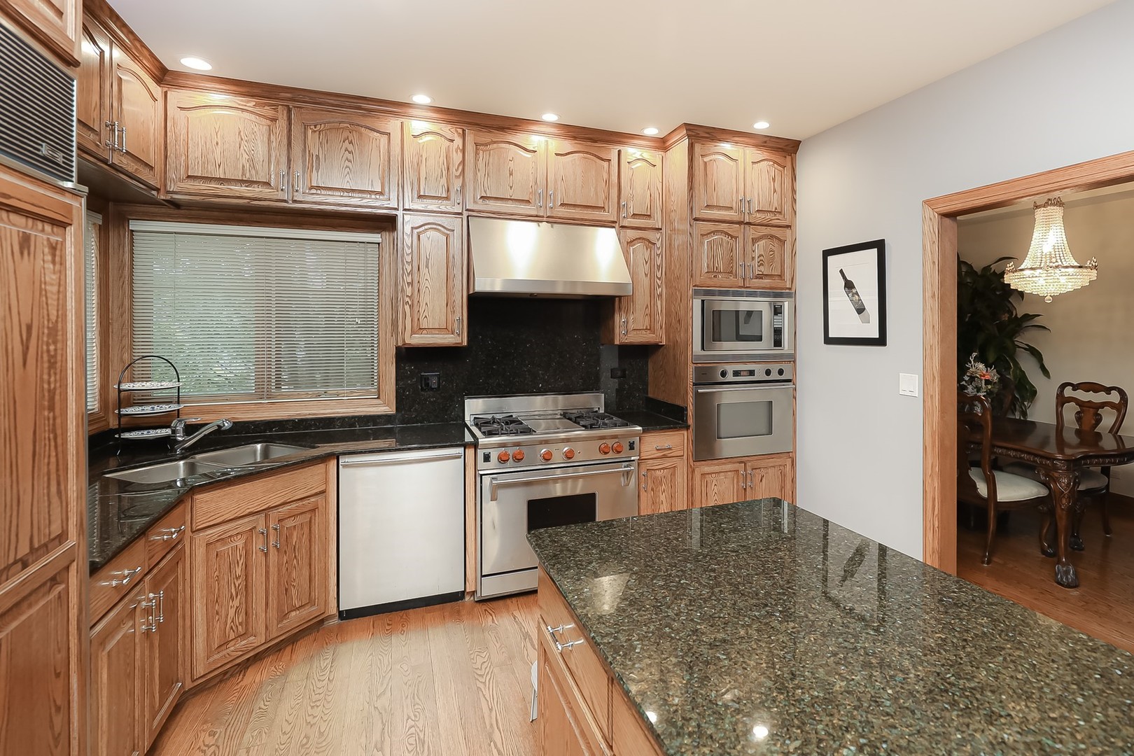 307 79th Street Burr Ridge, IL 60527 - Photo 14 of 41 a kitchen with cabinets and wooden floor