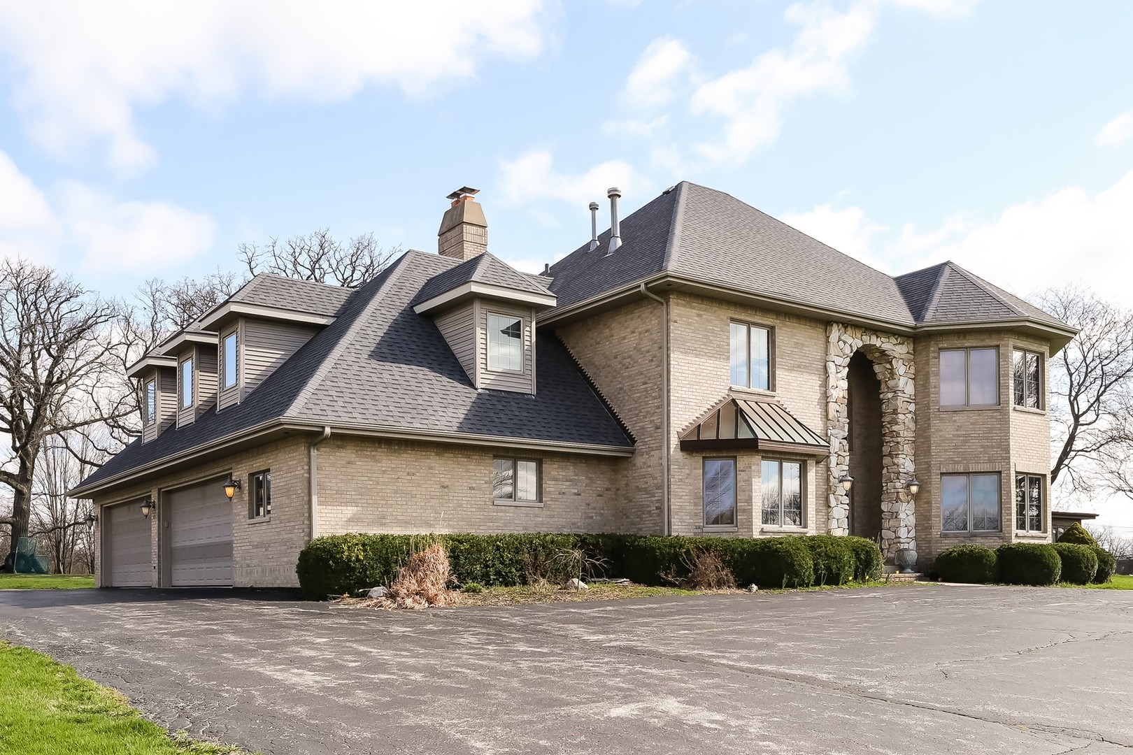 307 79th Street Burr Ridge, IL 60527 - Photo 2 of 41 a front view of a house with a yard and garage