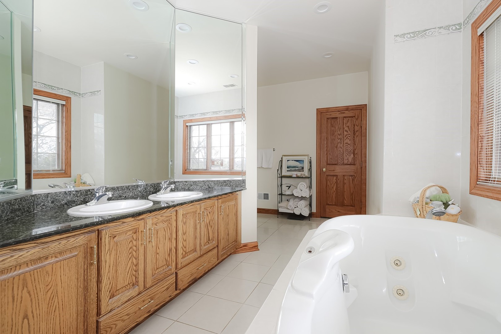 307 79th Street Burr Ridge, IL 60527 - Photo 22 of 41 a spacious bathroom with a granite countertop sink and a mirror