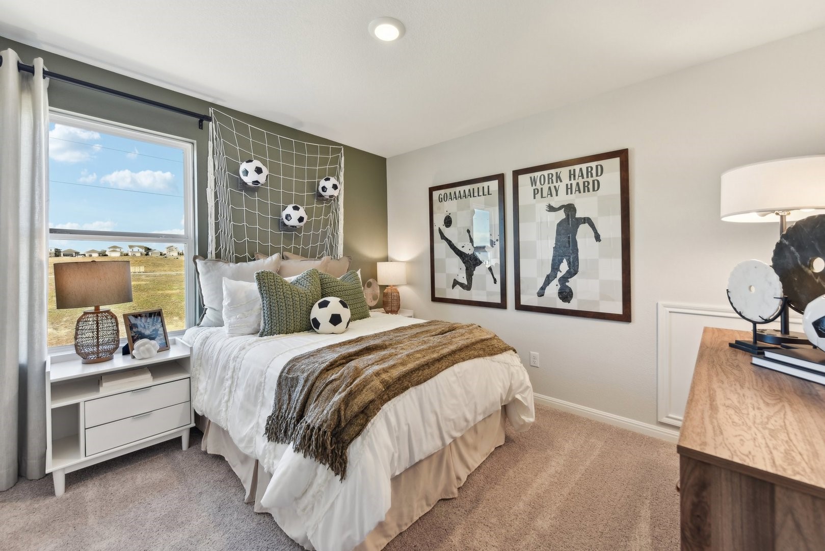 216 Firefox Way Jarrell, TX 76537 - Photo 17 of 17 A well-lit bedroom features plush carpeting, recessed lighting, and a window overlooking the neighborhood.