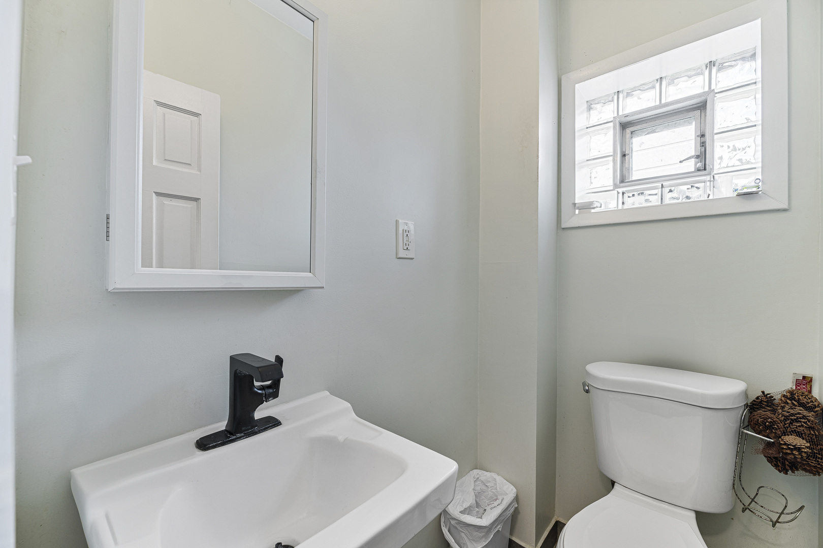 1S217 Valley Road Lombard, IL 60148 - Photo 11 of 25 a bathroom with a toilet sink and mirror