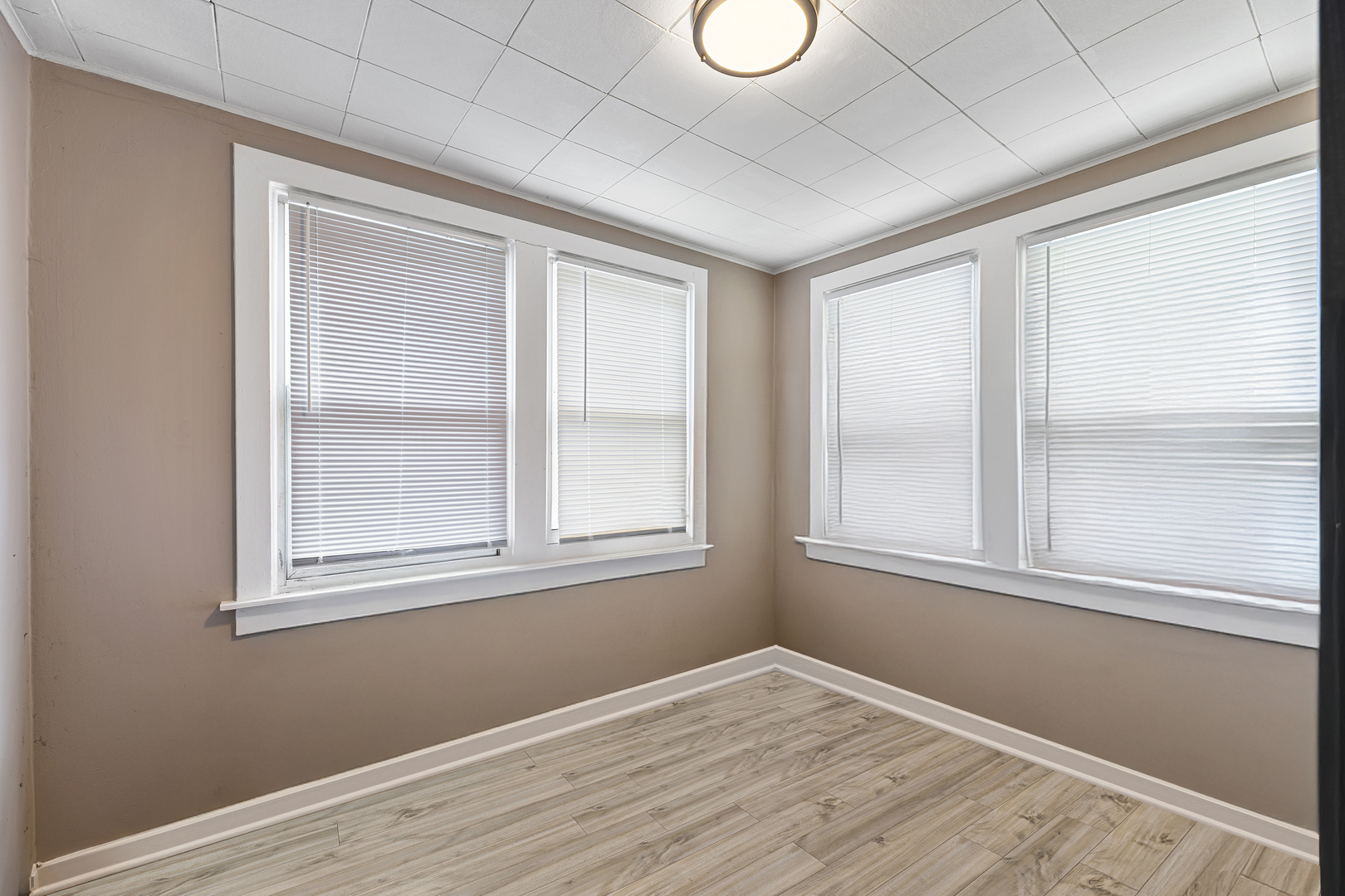 1S217 Valley Road Lombard, IL 60148 - Photo 12 of 25 an empty room with wooden floor and windows