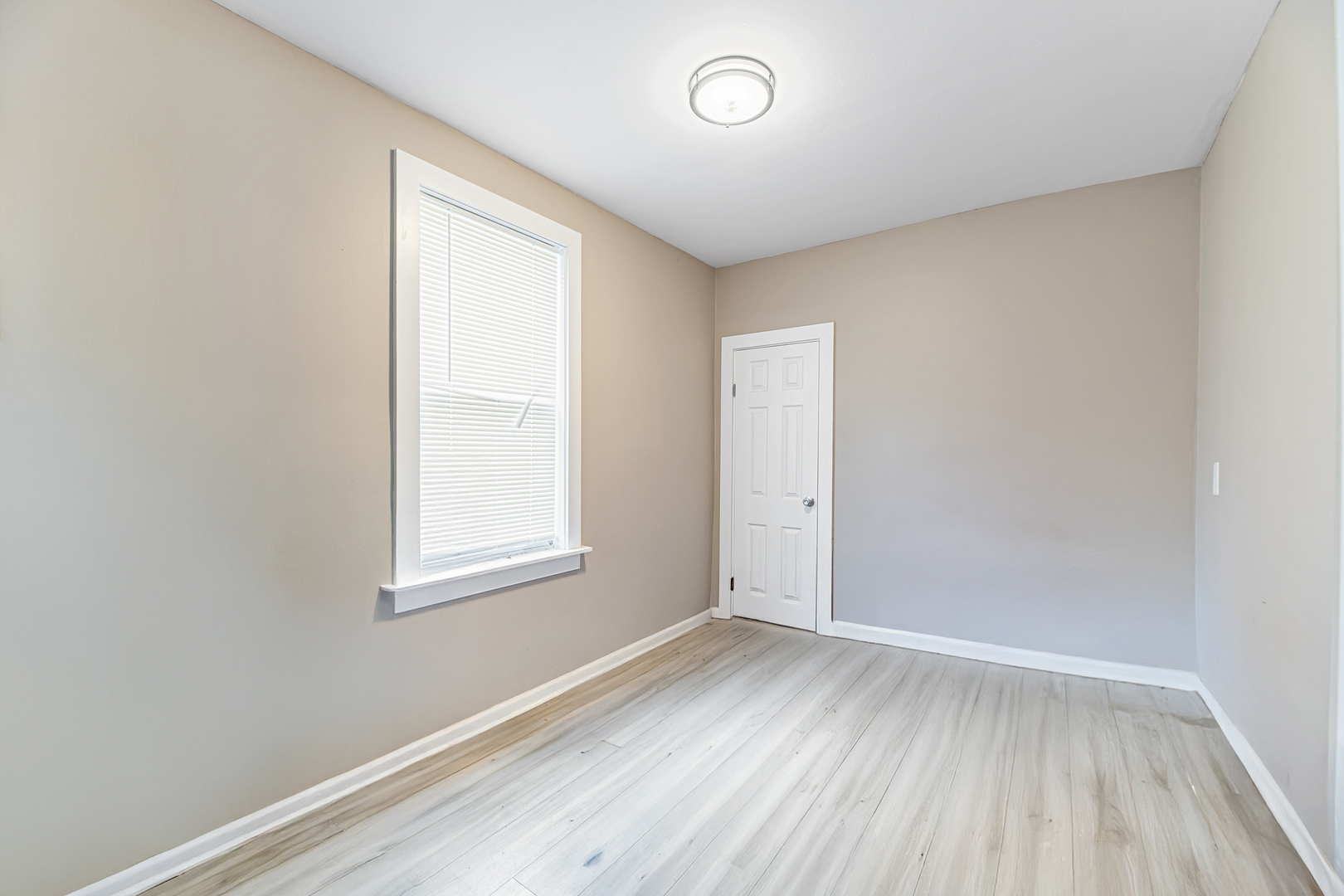 1S217 Valley Road Lombard, IL 60148 - Photo 10 of 25 an empty room with wooden floor and windows