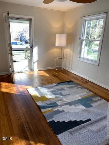 a view of empty room with wooden floor