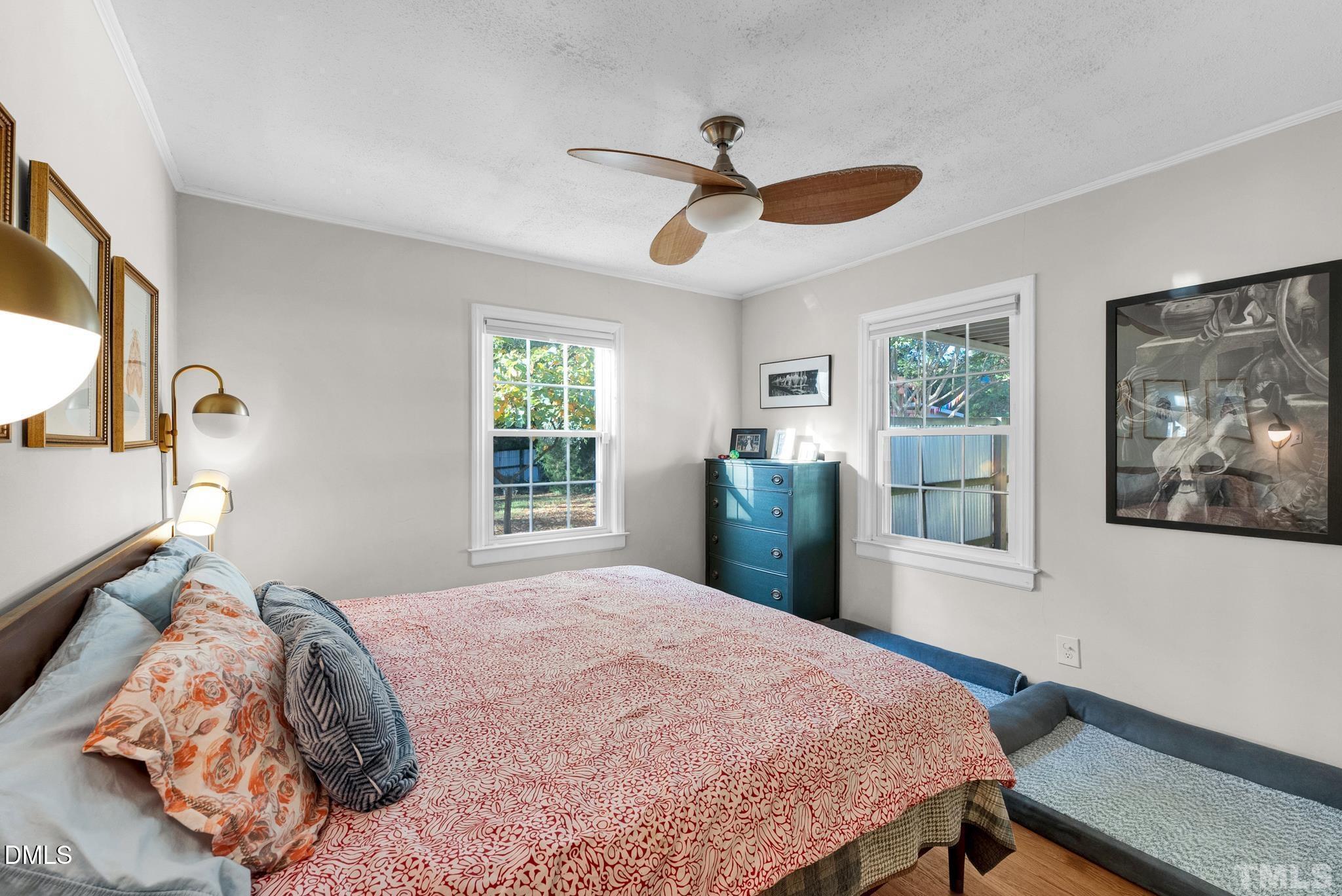 2106 Tudor Place Raleigh, NC 27610 - Photo 6 of 11 a bedroom with a large bed and a window