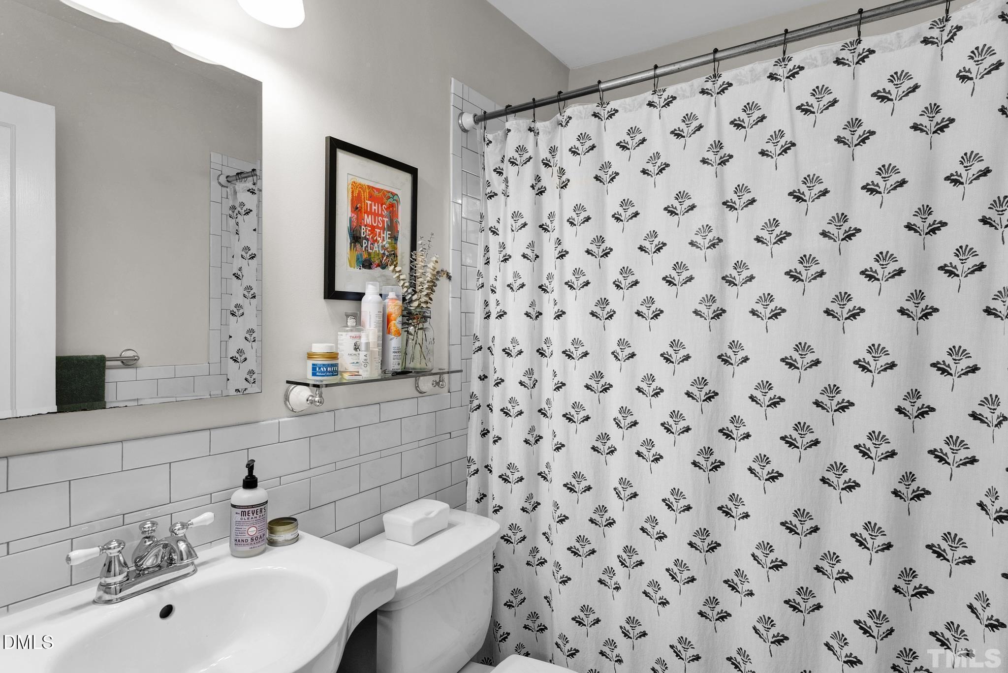 2106 Tudor Place Raleigh, NC 27610 - Photo 7 of 11 a bathroom with a sink and a mirror