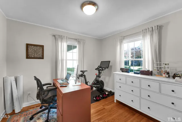 a view of a workspace with furniture and a window