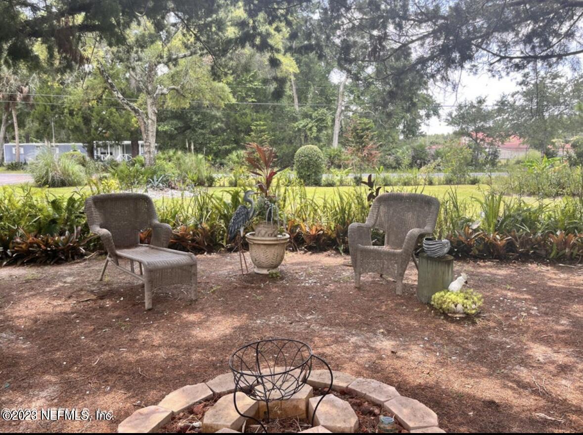 96089 Maranatha Road Yulee, FL 32097 - Photo 1 of 18 a view of a porch with furniture and a yard