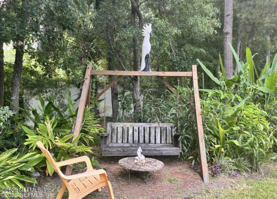 96089 Maranatha Road Yulee, FL 32097 - Photo 13 of 18 a view of a chair and table in the backyard