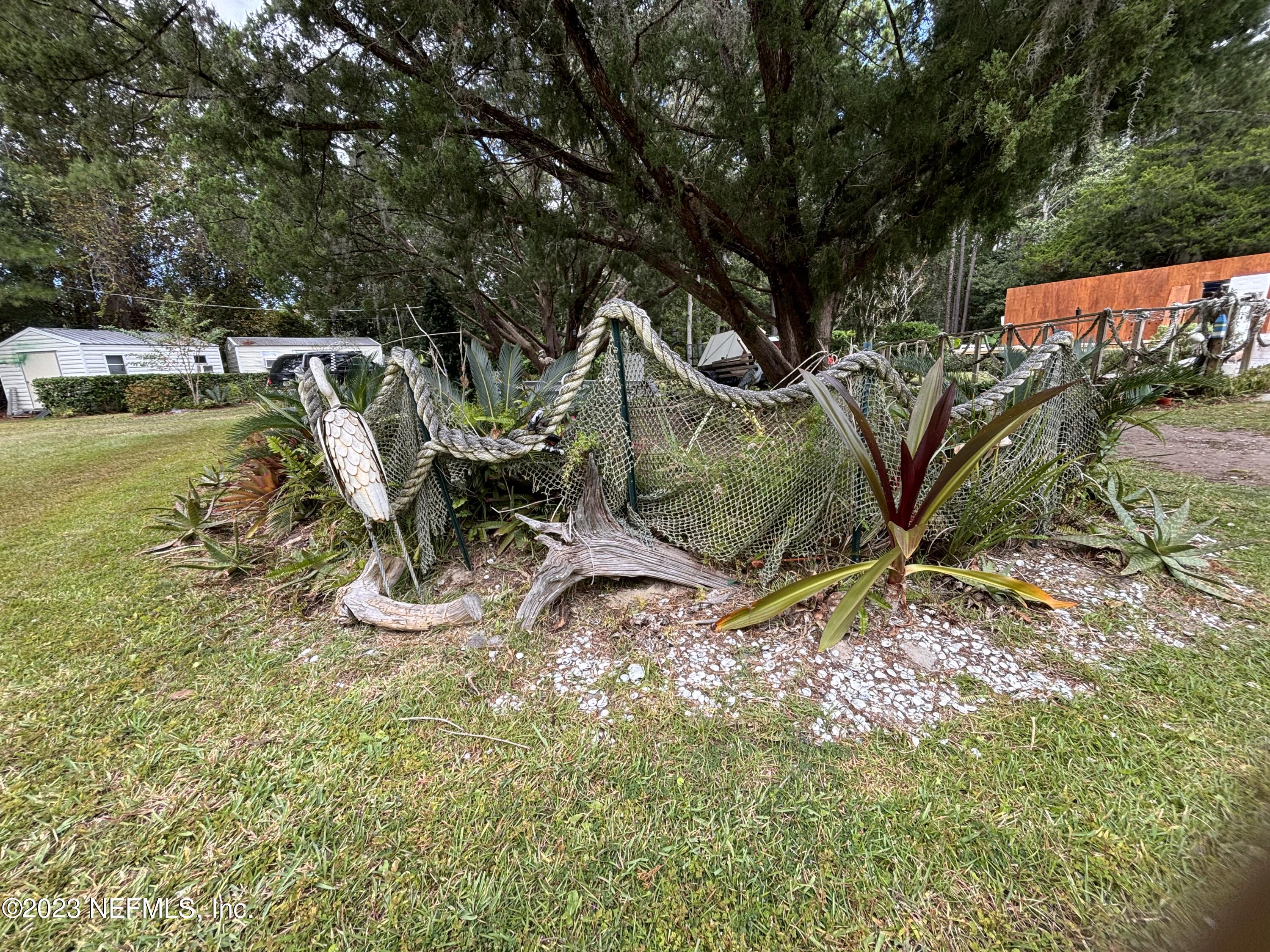 96089 Maranatha Road Yulee, FL 32097 - Photo 16 of 18 a view of swimming pool with a yard