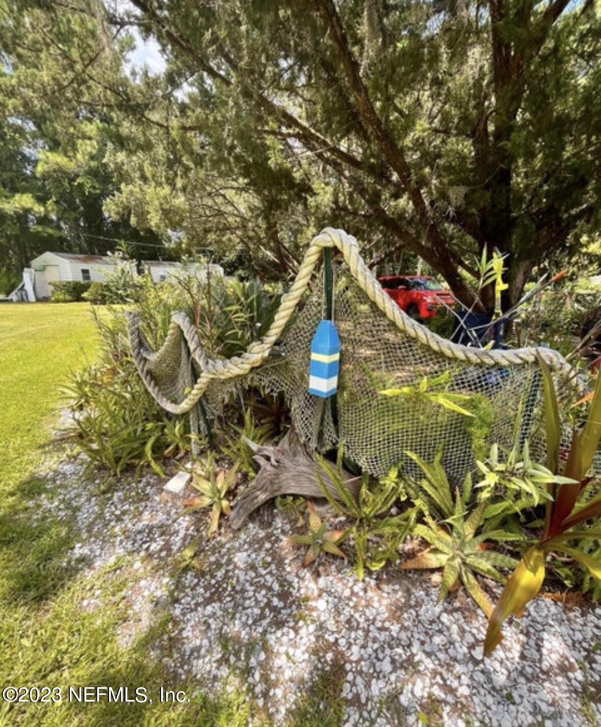 96089 Maranatha Road Yulee, FL 32097 - Photo 2 of 18 a view of a houses with swimming pool