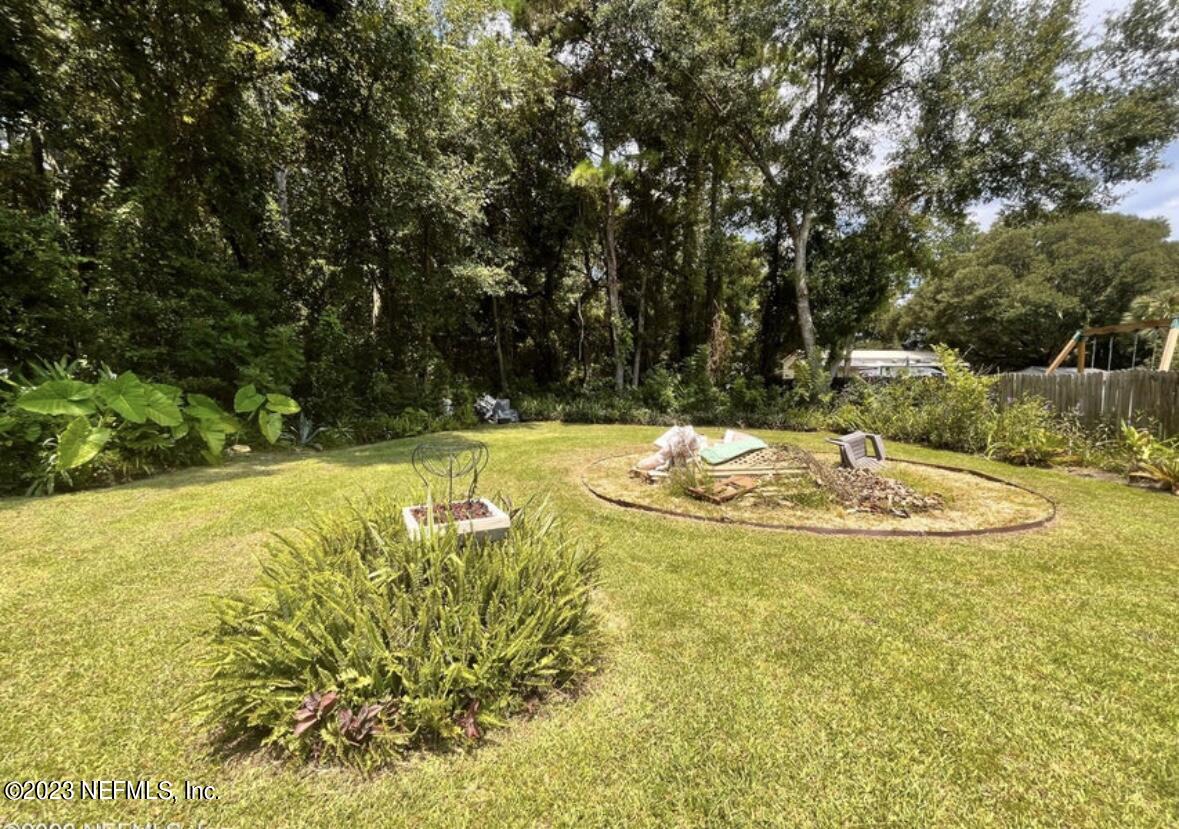 96089 Maranatha Road Yulee, FL 32097 - Photo 5 of 18 a view of a swimming pool with an outdoor space and seating area