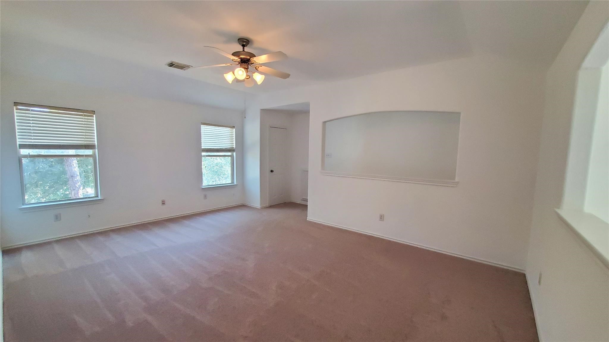 2814 Silver Point Lane Rosharon, TX 77583 - Photo 16 of 29 an empty room with chandelier fan and windows