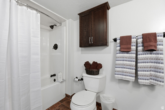 2342 Charros Road Sandy, UT 84092 - Photo 56 of 94 White bathtub and shower combination with dark bronze fixtures