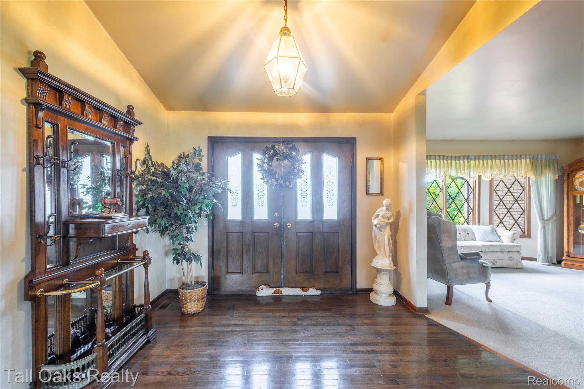 79330 Capac Road Armada, MI 48005 - Photo 29 of 42 Entry foyer featuring wood-finish flooring, a double entry door with decorative glass inserts, and an overhead pendant light fixture