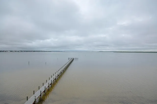 a view of a hardwood floor and staircase