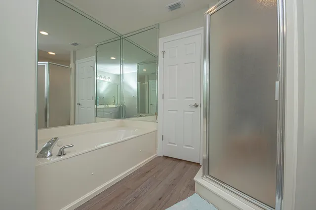a bathroom with a bathtub and a shower