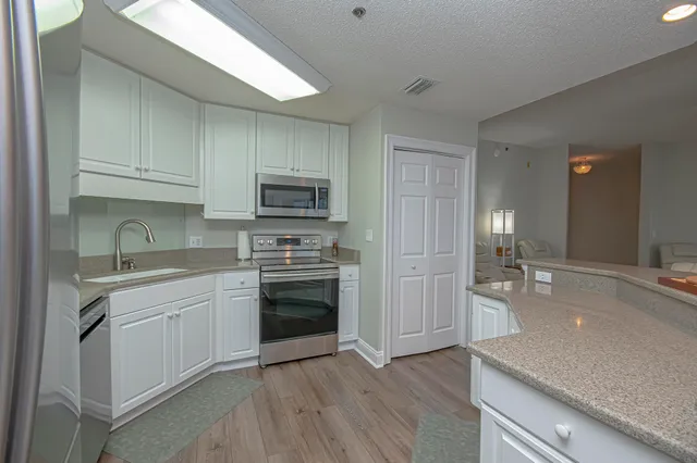 a kitchen with a sink stove and cabinets