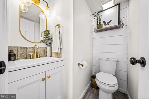 a bathroom with a toilet sink and mirror