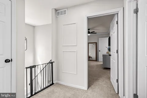 a view of hallway with livingroom and furniture