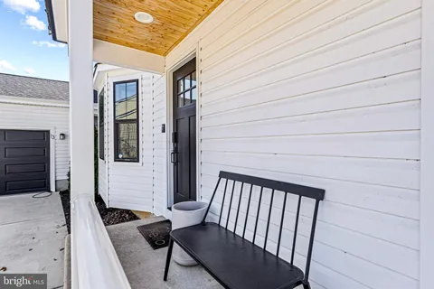a view of a balcony with chairs and wooden floor