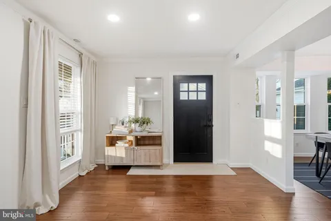 a view of a big room with wooden floor and windows