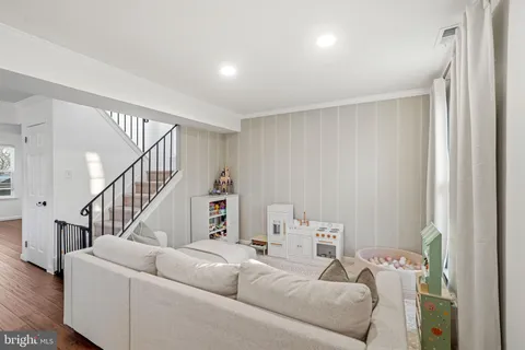 a living room with furniture and stairs