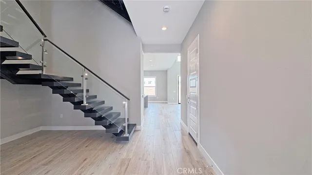 a view of entryway with wooden floor and stairs