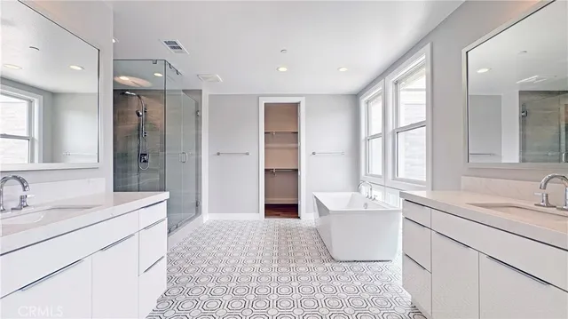a bathroom with a sink double vanity and a bathtub