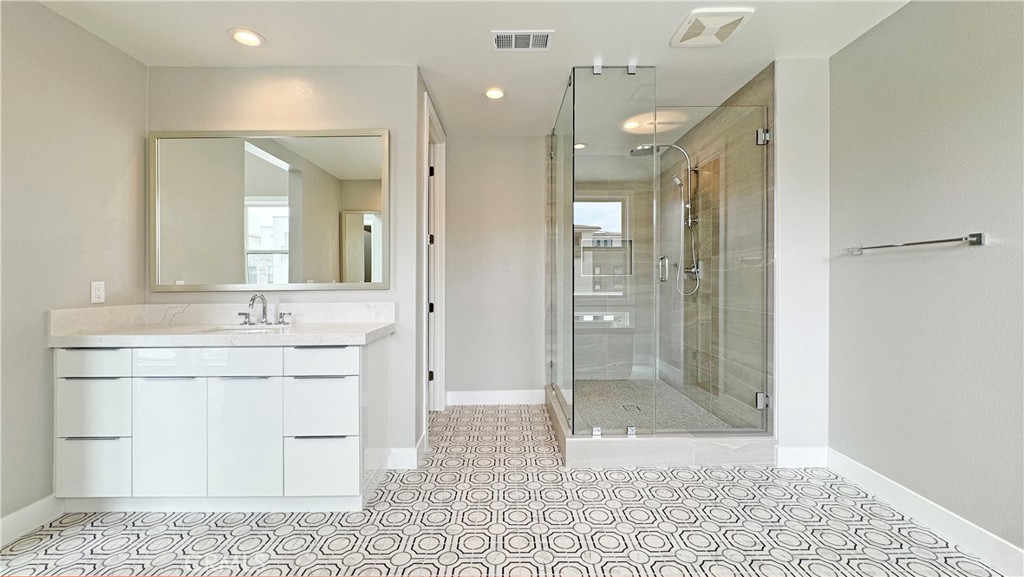 217 Stage Irvine, CA 92618 - Photo 17 of 26 a bathroom with a granite countertop sink mirror and shower