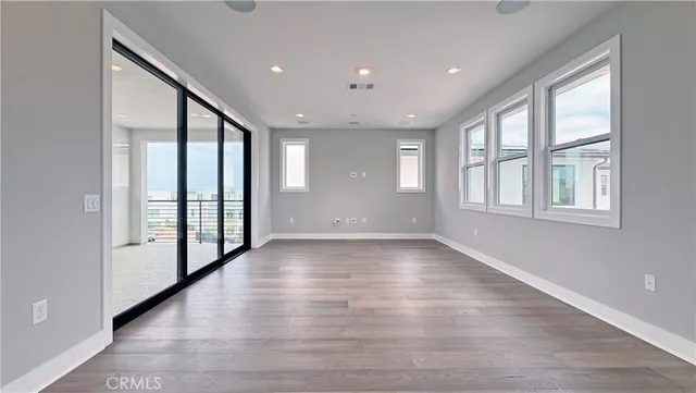 a view of an entryway with wooden floor and windows